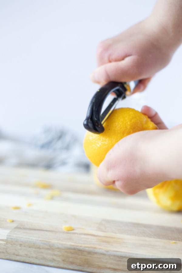 peeling a lemon with a vegetable peeler