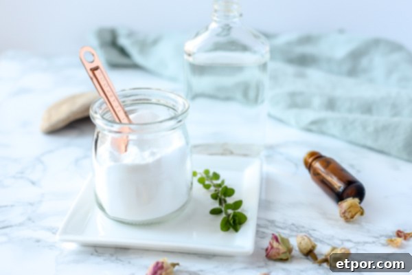 natural homemade toilet cleaner in a glass dish on a white plate with herbs