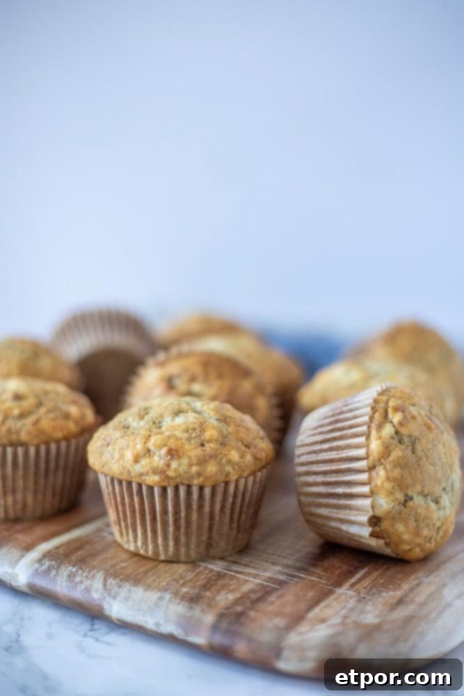 A stack of sourdough banana muffins on a wooden cutting board, ready to be enjoyed for breakfast or a snack.