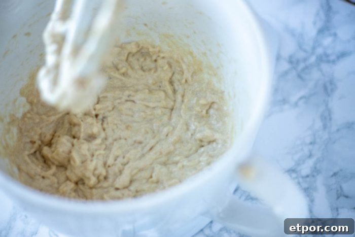 Sourdough banana muffin batter being mixed in a stand mixer.