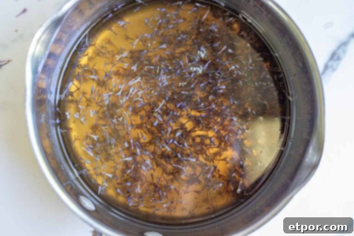 Lilac blossoms being steeped syrup. 