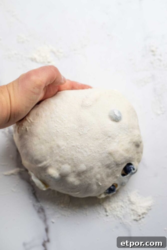 Creating tension in bread dough on a countertop.