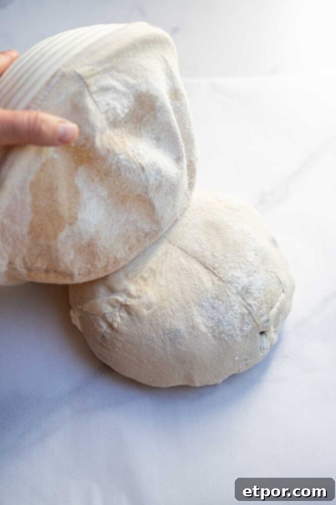 Turning bread dough out onto a countertop.