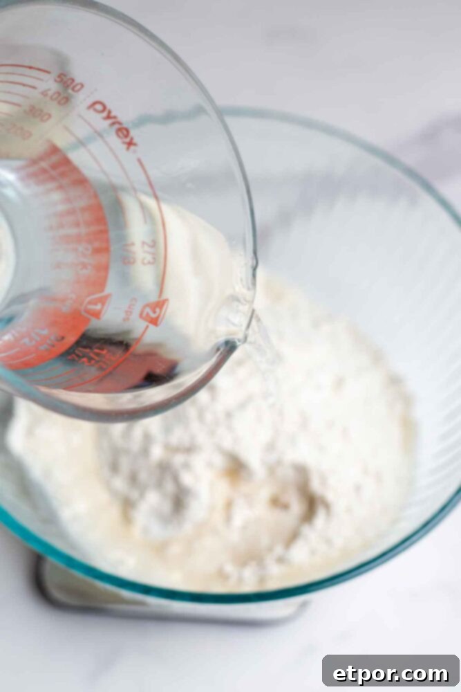 Pouring water into flour on a kitchen scale.