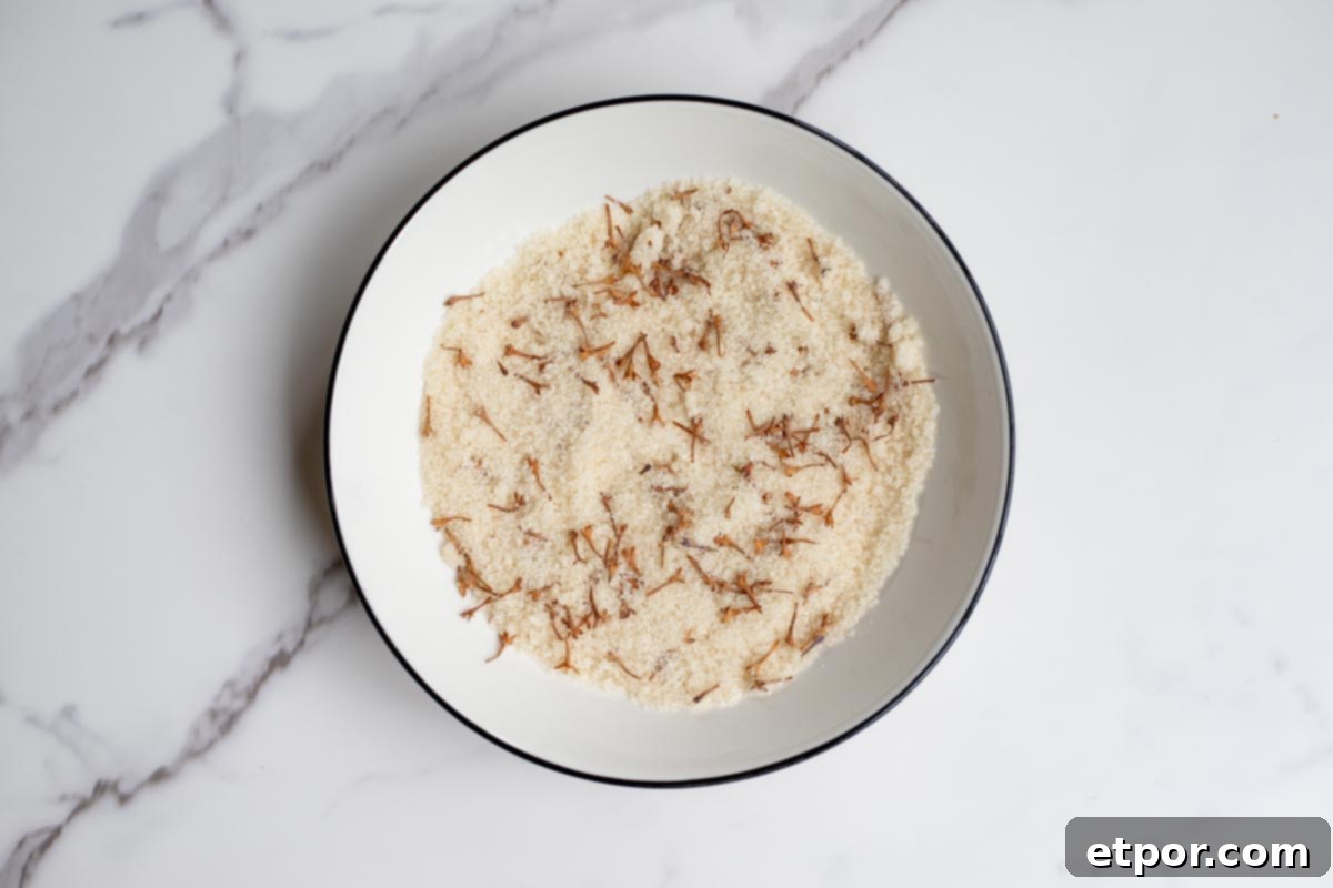 lilac sugar with dried lilac flowers in a bowl drying out.