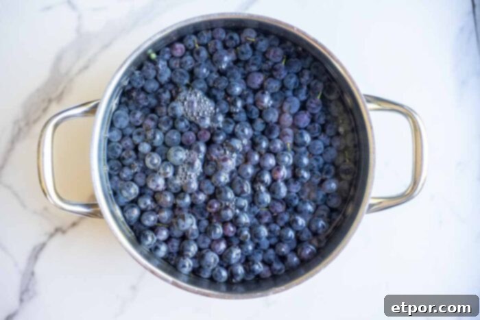 Grapes added to a pot and filled with water.