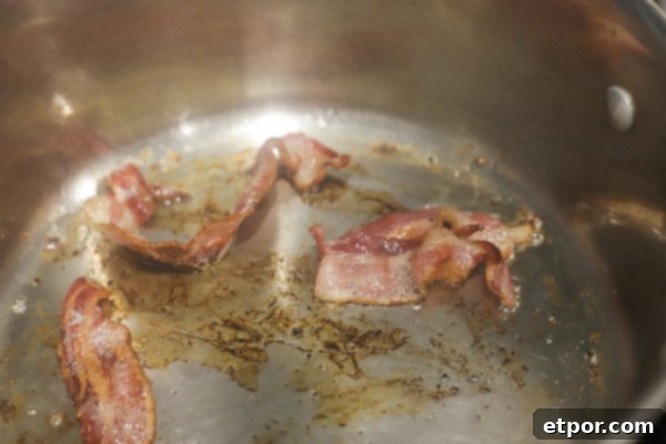 bacon sautéing in a pot