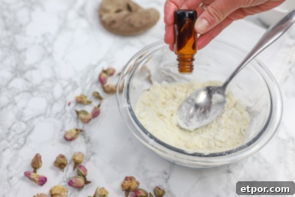 Adding essential oils to the DIY deodorant mixture for fragrance and added benefits.