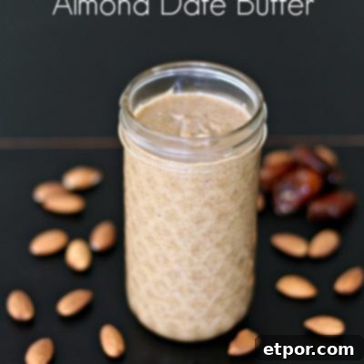 homemade almond butter in a mason jar with almond and dates spread around