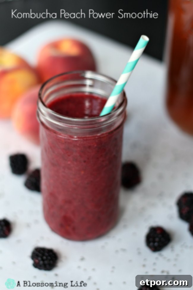A beautifully composed image of a berry peach smoothie in a clear glass jar with a straw, surrounded by fresh, vibrant peaches and dark blackberries, inviting a healthy and delicious experience.