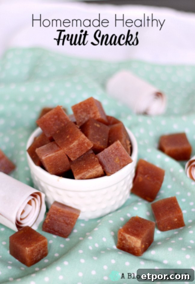 Homemade healthy fruit snacks in a white bowl sitting on top of teal and white polk-a-dot napkin