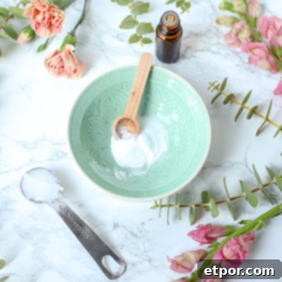 baking soda in a teal bowl with flowers around to make diy face scrub