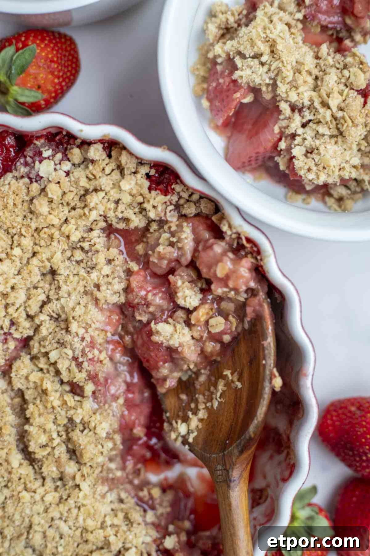 Simple Strawberry Crumble Bliss 2 strawberry crumble with a scoop taken out and a spoon sitting in the dish.