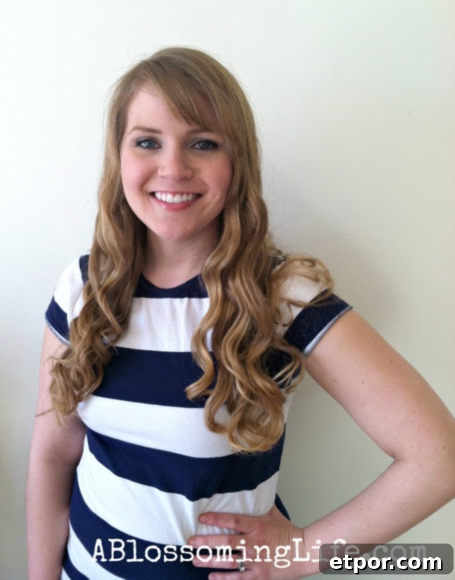 women with a white and blue stripped shirt showing off flat iron curls - how to curl your hair with a flat iron