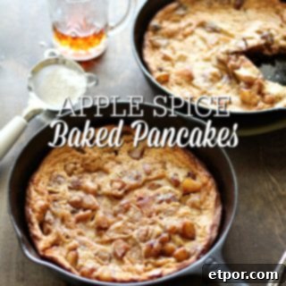 A beautifully baked Apple Spice Dutch Baby Pancake, golden brown and puffed, with a sprinkle of powdered sugar.