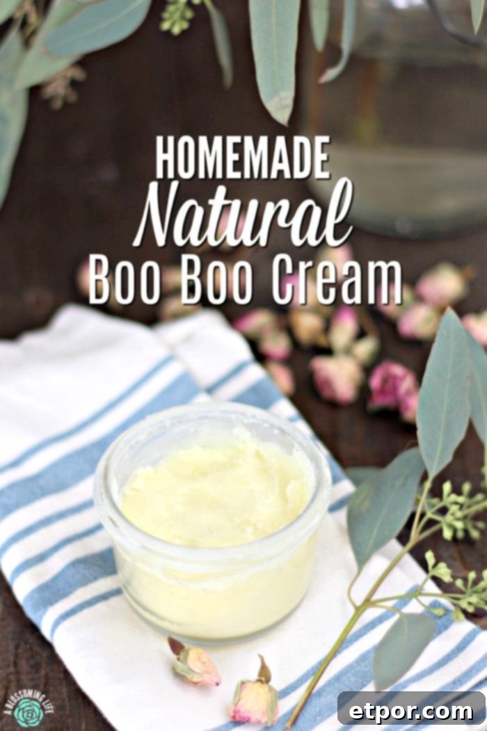 natural boo boo cream in a glass jar with eucalyptus around it