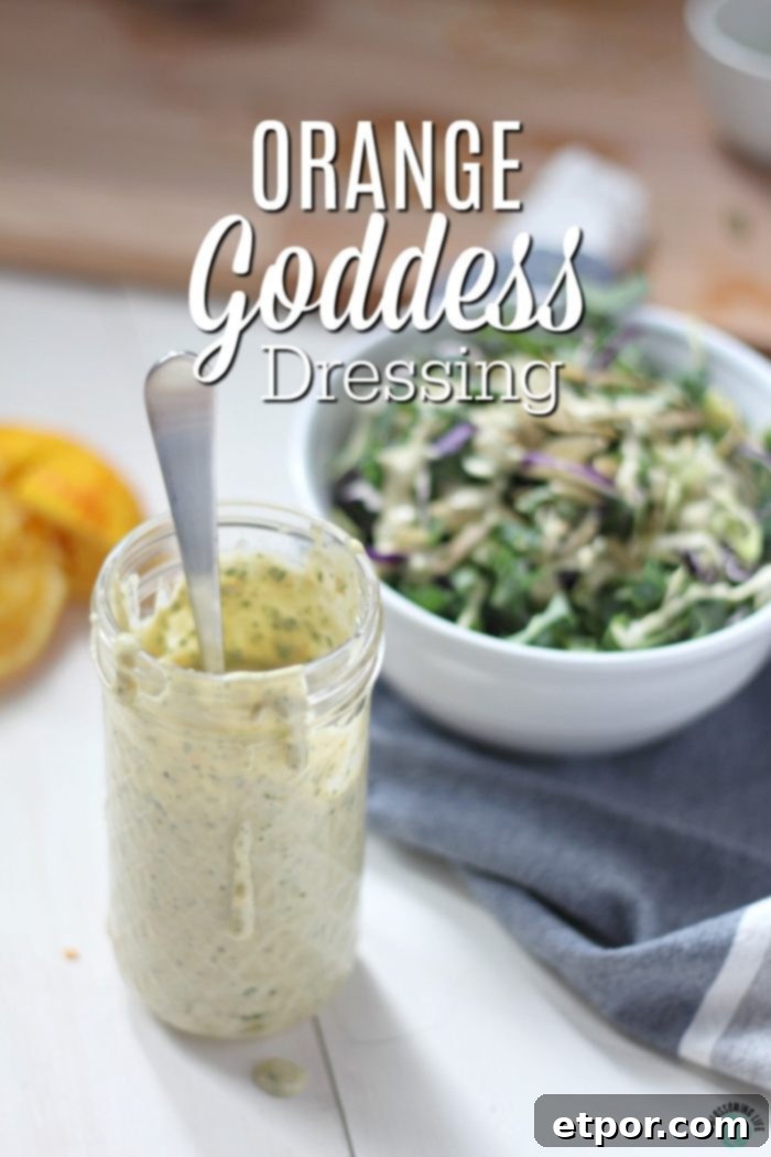 Radiant Orange Goddess Dressing 2 Orange Goddess Dressing in a glass jar with a kale salad behind it