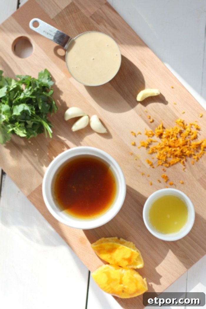 Radiant Orange Goddess Dressing 4 ingredients to make goddess dressing on a wooden cutting board