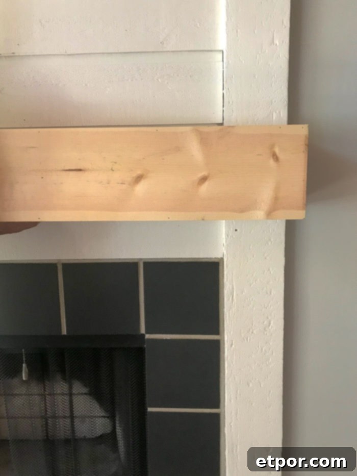 Dry fitting a DIY Fireplace mantel into place to check for proper fit and alignment before final finishing
