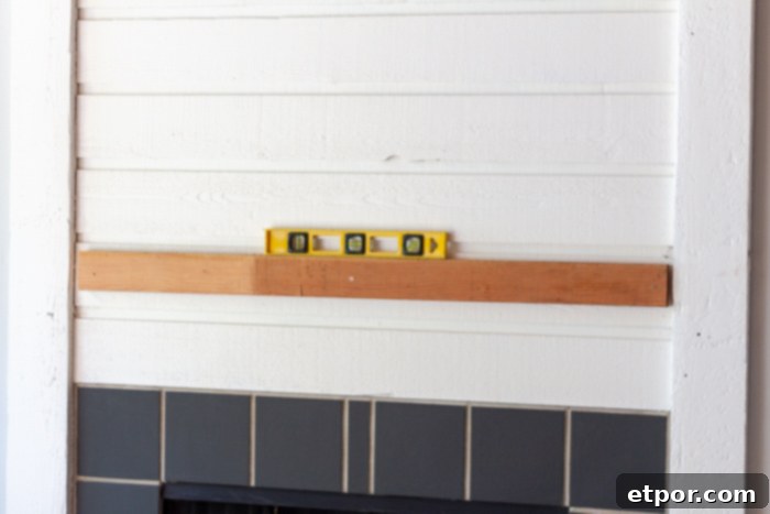 Hanging fireplace mantel using a 2x4 cleat for secure and hidden support