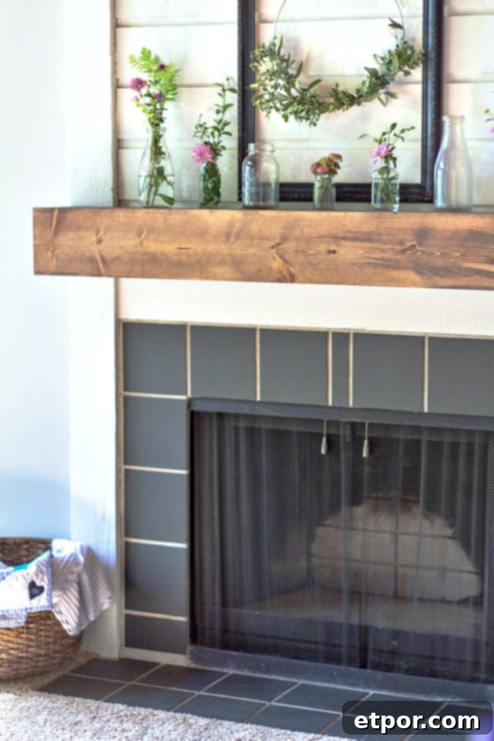 DIY fireplace mantel on a white fireplace with black tiles, showcasing a successful home renovation