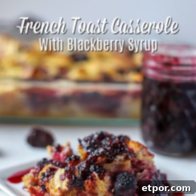 Slice of French Toast Casserole with Blackberries covered with blackberry syrup and a baking dish and jar of blackberry syrup in the back