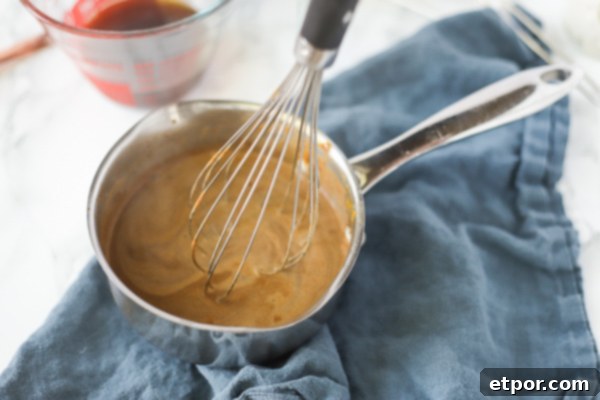 whisking together ingredients to make pumpkin spice creamer for a vegan pumpkin spice latte