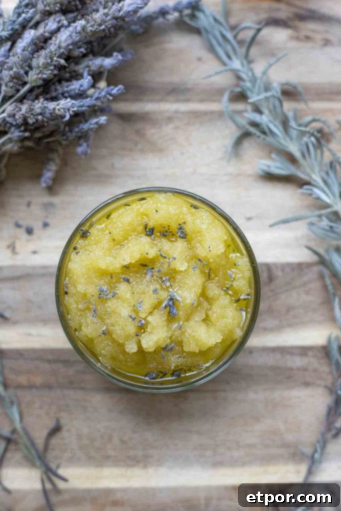 Homemade Lavender Bliss Body Polish 11 overhead photo of a sugar scrub on a wood cutting board and dried lavender frames the jar