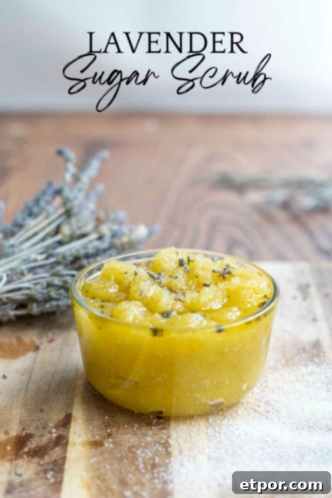 Homemade Lavender Bliss Body Polish 3 small glass jar of lavender sugar scrub topped with dried lavender flowers on a wood cutting board. A bundle of dried flower is in the background