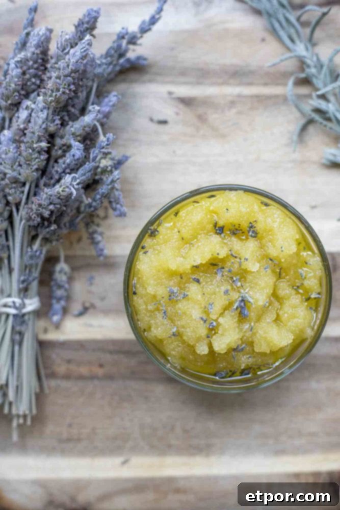Homemade Lavender Bliss Body Polish 5 overhead photo of a bundle of dried lavender flowers and a jar of lavender sugar scrub on a wood cutting board