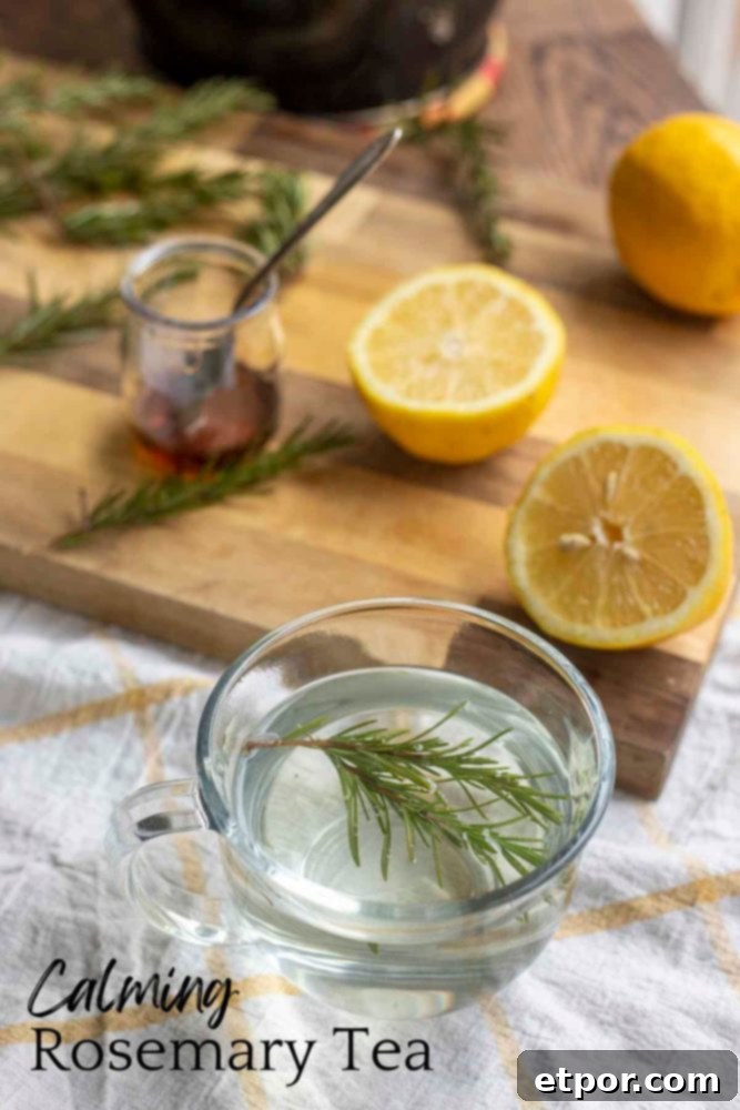 fresh sprigs of rosemary in a glass mug on a white and yellow towel with a wood cutting board with sliced lemons and a jar of honey in the background