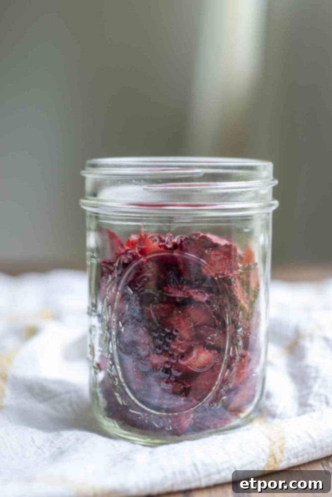 Mastering Homemade Dehydrated Strawberries 3 jar of dehydrated strawberries on a white and yellow checked towel