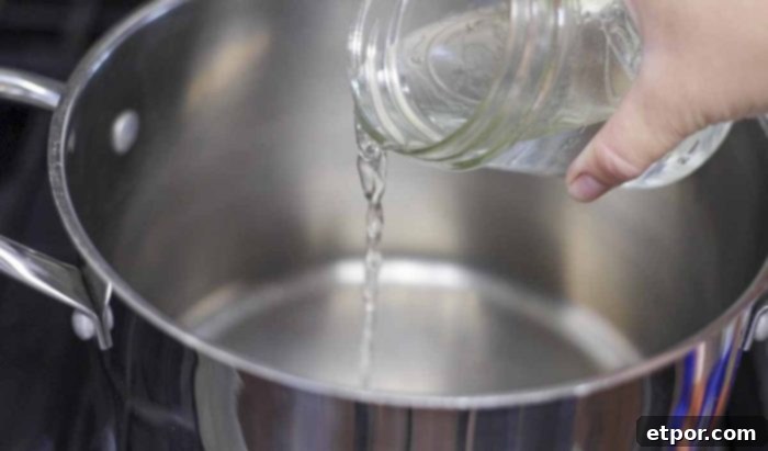 adding water in a mason jar to a pot