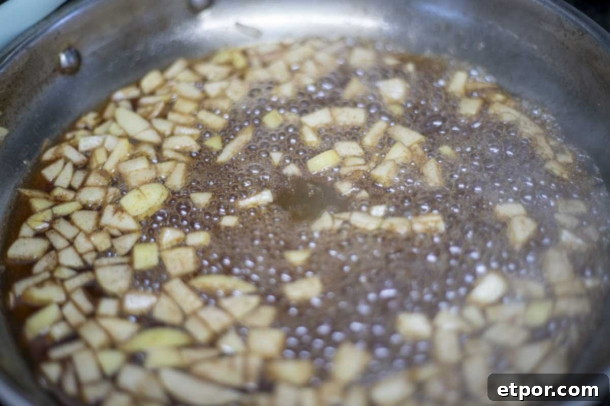apples simmering in brown sugar, water, and cinnamon.