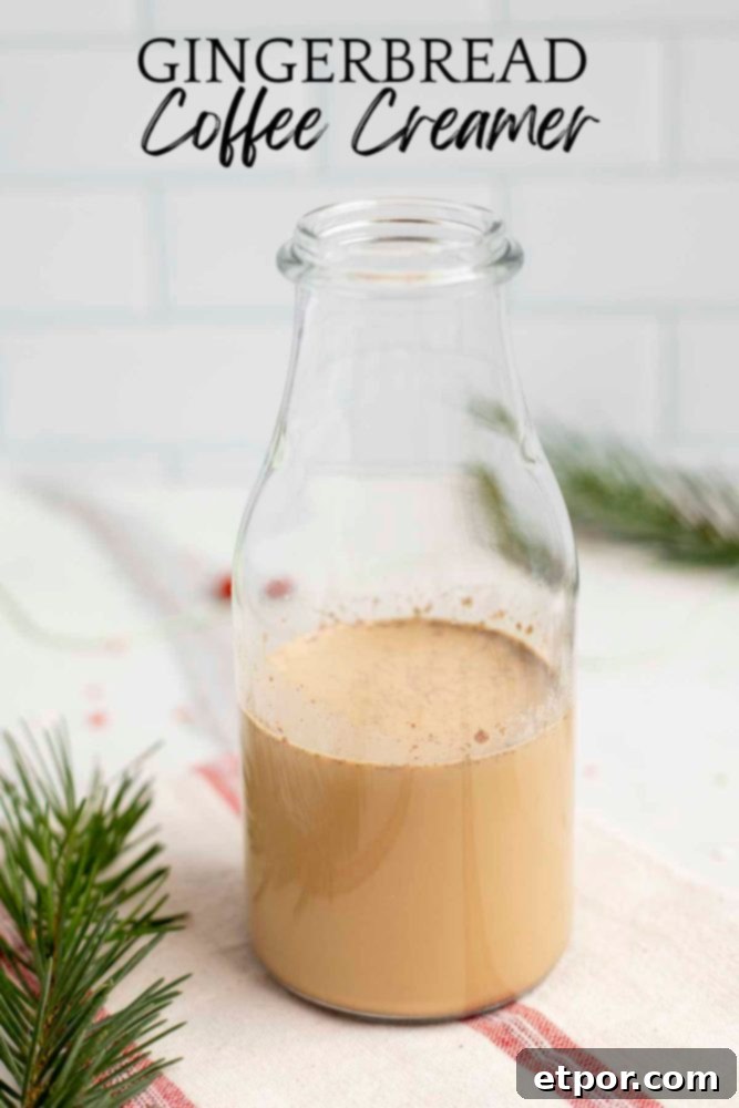 Whip Up Homemade Gingerbread Coffee Creamer 2 gingerbread coffee creamer in a glass bottle on a white and red stripped towel with greenery to the left