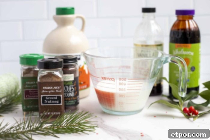 Whip Up Homemade Gingerbread Coffee Creamer 4 half and half in a class measuring cup, with maple syrup, vanilla, and molasses behind the cream. 3 jars of spices to the left.