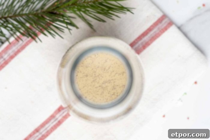 Whip Up Homemade Gingerbread Coffee Creamer 9 overhead photo of gingerbread creamer in a glass jar on a white and red stripped towel