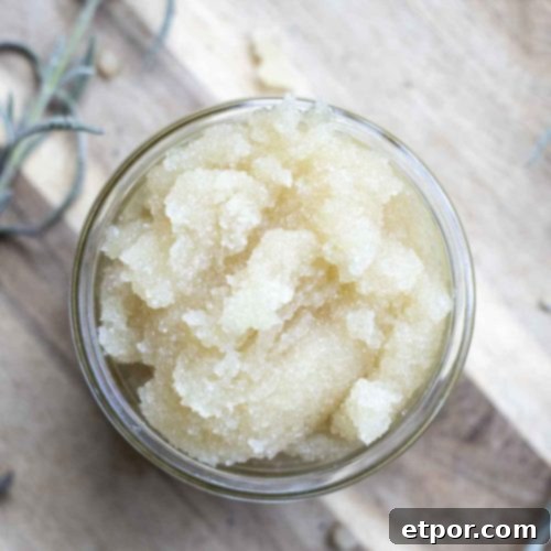 overhead photo of peppermint sugar scrub on a wood cutting board with fresh sprigs of lavender
