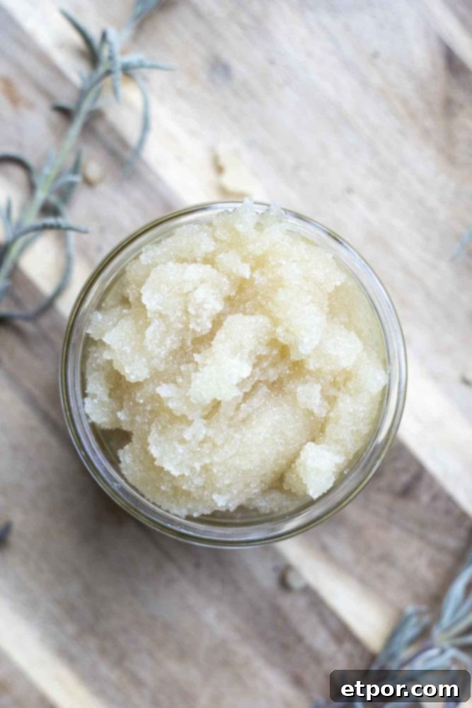 overhead photo of peppermint sugar scrub on a wood cutting board with fresh sprigs of lavender