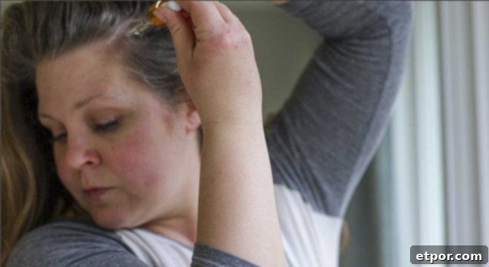 Boost Hair Growth with Homemade Rosemary Oil 11 A woman adding rosemary oil to her scalp scalp