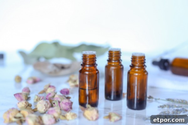3 bottles of essential oils with dried plants around