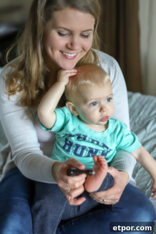mom putting essential oils on toddlers feet