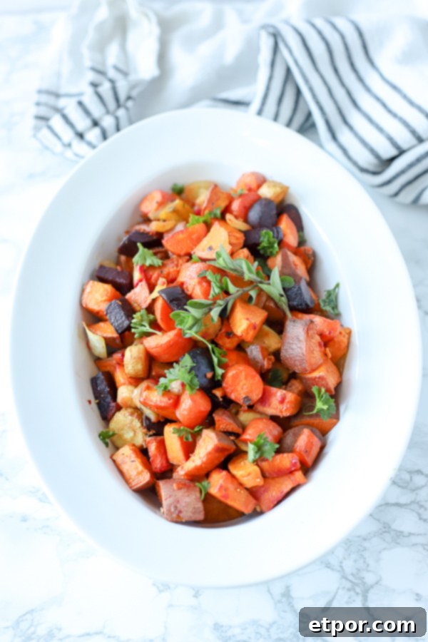 Rustic Roasted Root Vegetables 5 roasted root vegetables in a white bowl with a black and white striped towel behind it, a perfect healthy side dish