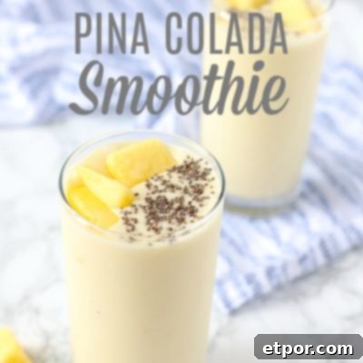 Guilt-Free Tropical Pina Colada Delight 5 pina colada smoothie recipe in two glass cups topped with chia seeds and pineapples and placed on a blue and white napkin.