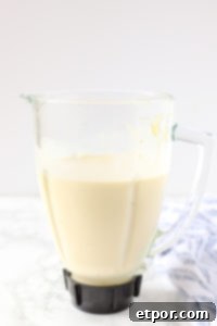 Guilt-Free Tropical Pina Colada Delight 7 pina colada smoothie blended in a blender pitcher