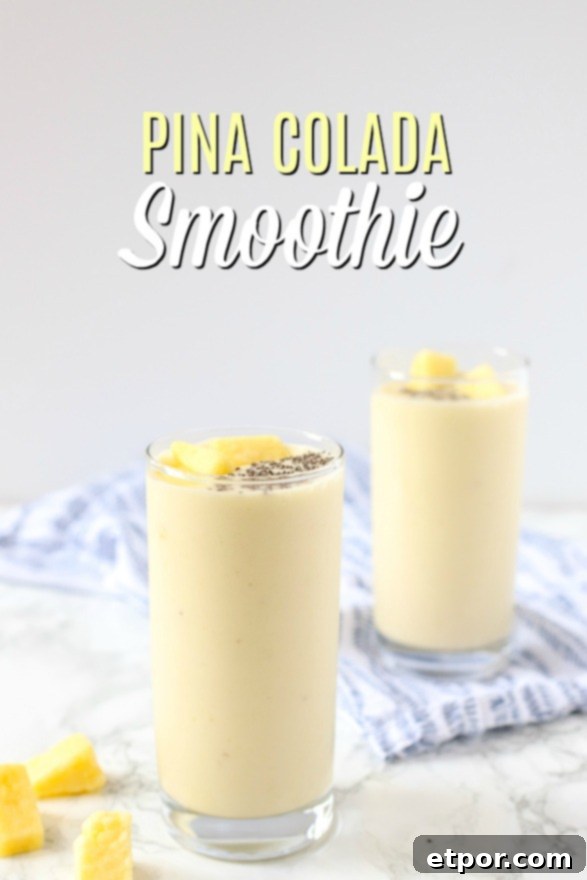 Guilt-Free Tropical Pina Colada Delight 8 pina colada smoothie in two glass cups and topped with chia seeds and pineapples on top a marble counter top with a blue and white napkin