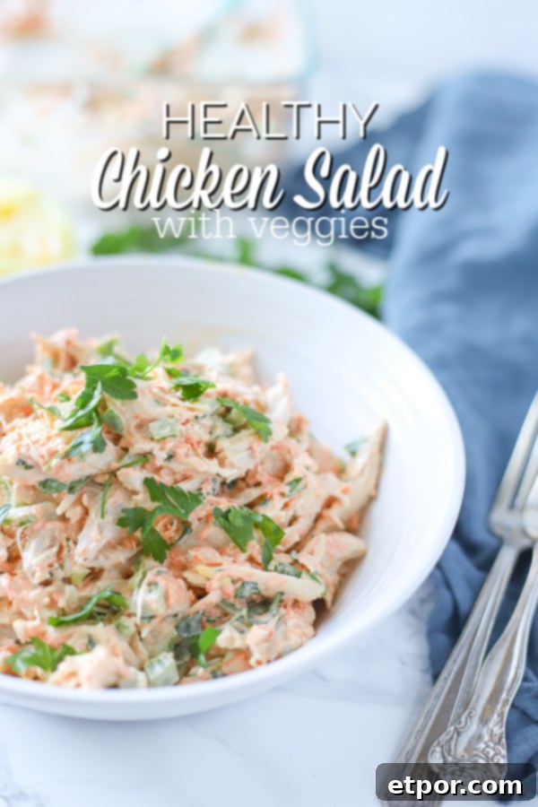 Zesty Garden Chicken Salad 2 healthy chicken salad in a white bowl on top a blue napkin with antique forks to the right