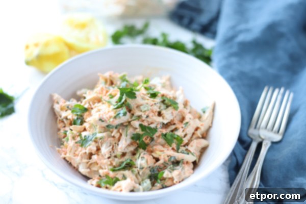 Zesty Garden Chicken Salad 4 healthy chicken salad in a white bowl with lemons behind it