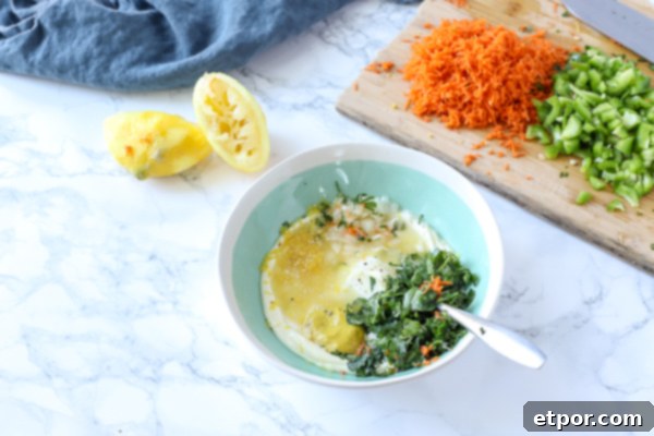 bowl of herbs, mayo, onion, and seasonings for chicken salad