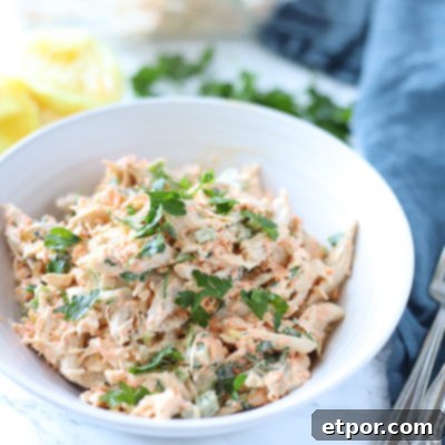 Zesty Garden Chicken Salad 9 healthy chicken salad in a white bowl with lemons behind it